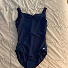 a blue swimsuit laying on top of a bed