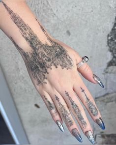 a woman's hand with tattoos on it