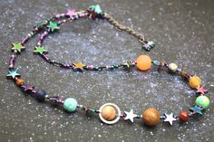 a beaded necklace with planets and stars on it