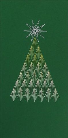 a christmas tree made out of white thread on a green background with an ornament in the middle