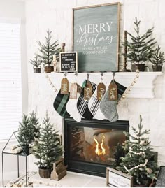 a fireplace with stockings hanging from the mantel and christmas decorations on it's mantle