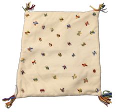 a small white bag with multicolored birds on it