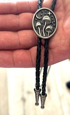 This awesome bolo features a mushroom design. It is solid stainless steel metal, handcrafted by our design team. Quality guaranteed, picture does not do this bolo justice! The piece measures 1 1/2'' x 1 1/4''. It can adjust lengths, 39'' in total length. We have matching belt buckles to pair! Hipster Cowboy, Mushroom Moon, Western Gifts, Western Necklaces, Black Food, Mens Necklace, Mushroom Design, Bolo Tie, Men's Necklace