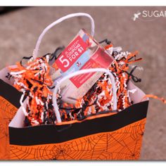 a trick or treat bag filled with candy and confetti for the halloween season