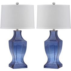 two blue vases with white lamps on them are shown in front of a white background