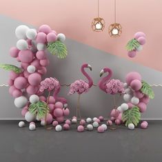 two pink flamingos surrounded by balloons and palm leaves