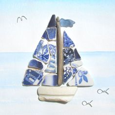 a sailboat made out of blue and white tiles