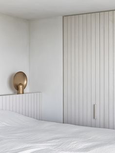 a bedroom with white walls and wood paneling