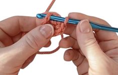 two hands crocheting the ends of a piece of yarn