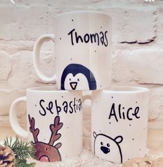 three white coffee mugs with cartoon animals on them and the words thomas, sebasa, alice