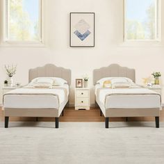 two beds sitting next to each other on top of a hard wood floored floor