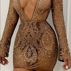 the back of a woman's bodysuit with gold sequins