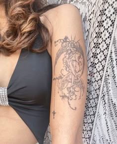 a woman with a tattoo on her arm