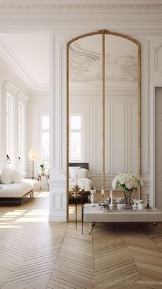 an elegant living room with white furniture and large mirrors on the wall, along with wooden flooring