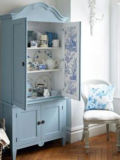 an image of a blue china cabinet in the living room