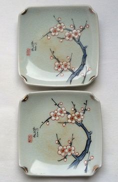 two small plates with flowers painted on them