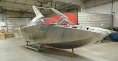 a silver boat is parked in a garage