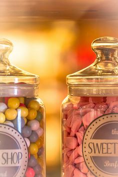 two glass jars filled with candy and candies