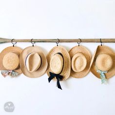 five hats are hanging on the wall