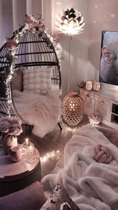 a living room filled with lots of furniture and lights on the walls, along with a birdcage