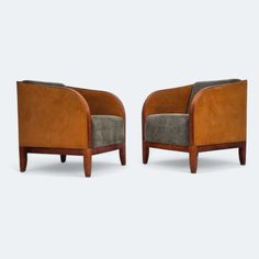 a pair of brown and grey chairs sitting next to each other