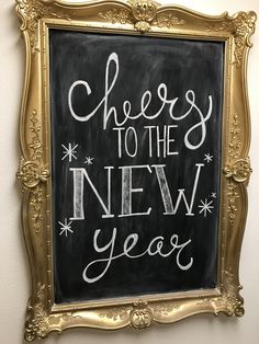 a chalkboard sign that says cheese to the new year