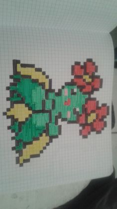 a piece of paper with an image of a green and red flower on it in the shape of a fish