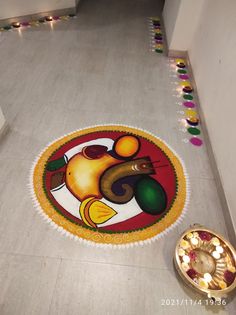 a decorated floor with an elephant on it and candles in the corner next to it