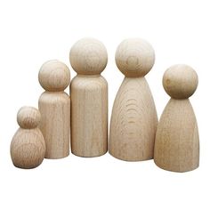 several wooden dolls are lined up on a white background