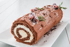 a cake roll with chocolate frosting and sprinkles on it