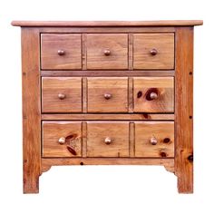 a wooden dresser with many drawers and knobs on the bottom drawer, isolated against a white background