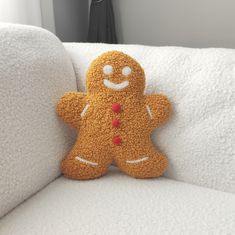 a stuffed ginger sitting on top of a white couch