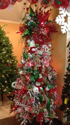 a christmas tree is decorated with red, green and silver ornaments in the shape of candy canes