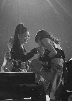 black and white photograph of two women on stage