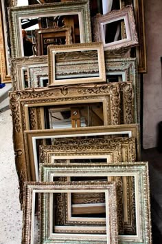 a bunch of old frames are stacked on top of each other