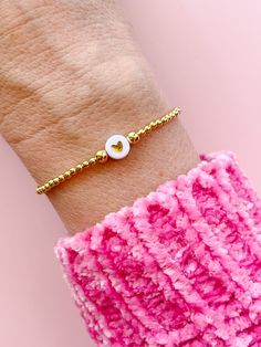 "this lovely little stretchy bracelet is made with tiny gold fill beads surrounding a single gold heart bead, and will be custom made for you in your chosen size. it's lightweight and delicate - a perfect piece to wear on its own or add to your favorite stack. these super trendy and versatile stretch bracelets are the perfect little accessory for your wrist. they are dainty and beautiful by themselves, but also look great when combined and stacked. you can add to your stack right here: http://ww Cute Gold Beaded Bracelets With Heart Beads, Dainty 14k Gold Filled Stretch Bracelet For Everyday, Gold Bracelets With Heart Beads, Dainty 14k Gold-filled Stretch Bracelet, Dainty 14k Gold Filled Stretch Bracelet, Dainty Stretch Bracelet With Heart Beads For Gift, Gold Heart-shaped Beaded Bracelets With Tiny Beads, Gold Heart Bracelet With Tiny Beads, Gold Dainty Beaded Bracelets With Heart Charm