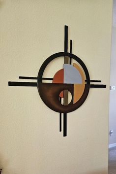 a clock mounted to the side of a wall with different colored circles on it's face