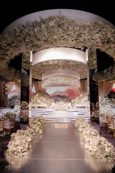 an elegant wedding setup with flowers and chandeliers