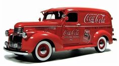 an old red coca cola truck is shown