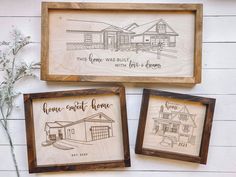 three framed wood signs with some drawings on them next to flowers and a wall hanging