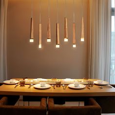 a dining room table with plates and utensils hanging from the ceiling