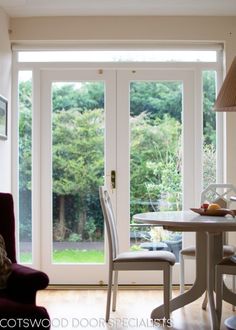 a table and chairs in front of a sliding glass door