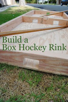 a wooden box with the words build a hockey rink on it in front of some grass