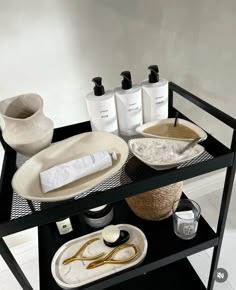 a black table topped with lots of different types of hair products and personal care items