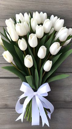 a bouquet of white tulips tied with a ribbon