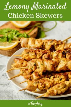 lemon marinated chicken skewers on a white plate