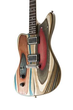 an electric guitar made out of wood and painted with different colors on the top, bottom and sides