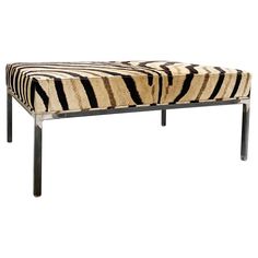 a zebra print bench with metal legs