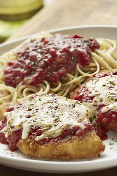 chicken parmesan and spaghetti on a white plate