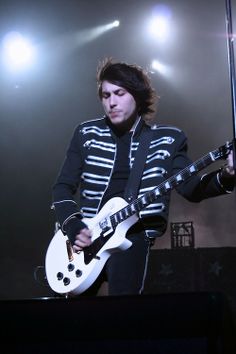 a man playing an electric guitar on stage